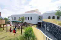 Children in the garden below Redhill Early Learning Centre by Hubo Studio