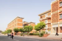 UCAD Dakar Student Housing by Hardel Le Bihan Architectes along its street in Dakar
