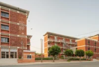 Terracotta brick facades of UCAD Dakar Student Housing by Hardel Le Bihan Architectes