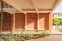Brick colonnade and planting at UCAD Dakar Student Housing by Hardel Le Bihan Architectes