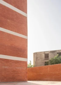 Brick corner with its white concrete bands at UCAD Dakar Student Housing