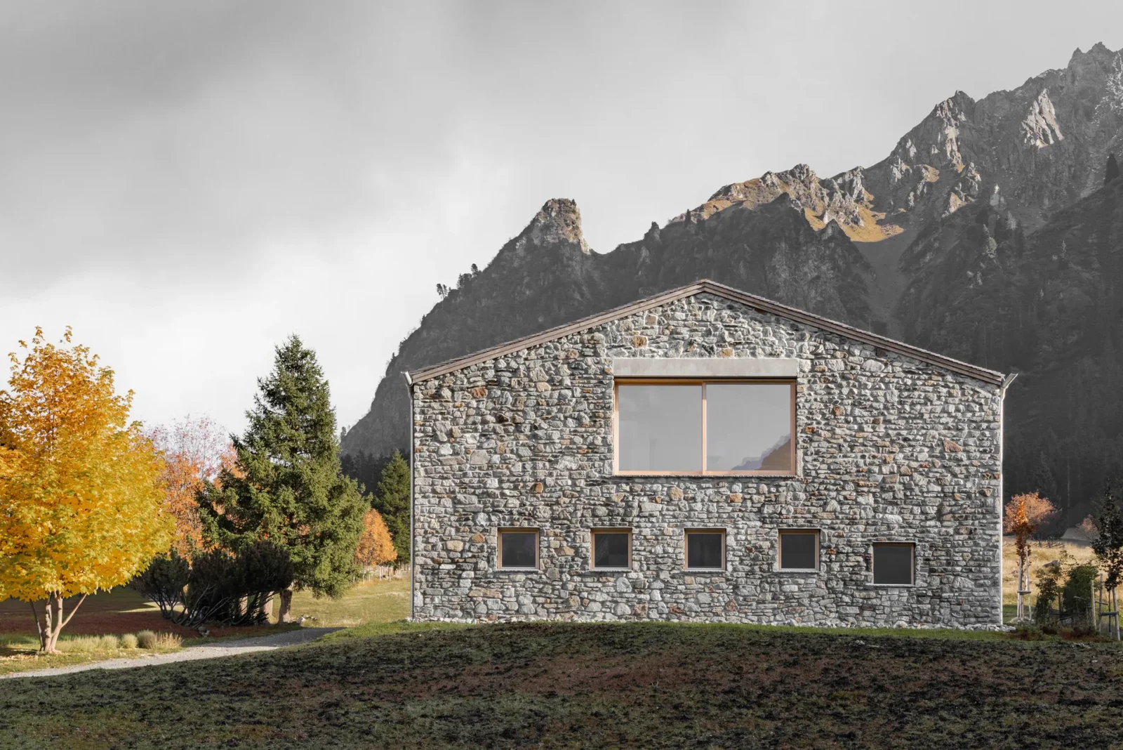 Vergalderie by Christian Tonko, its stone gable against the Montafon peaks in autumn