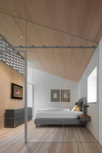 Bedroom under the pitched timber ceiling at Vergalderie by Christian Tonko