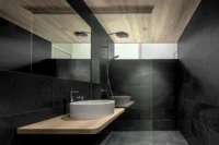 Dark stone bathroom at Vergalderie by Christian Tonko