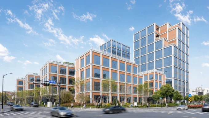 Street view of the glass tower rising behind terraced blocks with bronze panels along a busy road, Greentown ThinkWorks