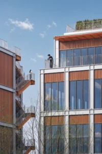 Terraces stepping back on an upper block with people standing on the rooftop, Greentown ThinkWorks