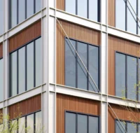 Facade detail of silver frames, bronze panels, windows and diagonal tie rods at a corner, Greentown ThinkWorks