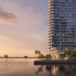 Rendering of the slender Lilli tower with curved balcony edges rising from a palm-lined waterfront at dusk