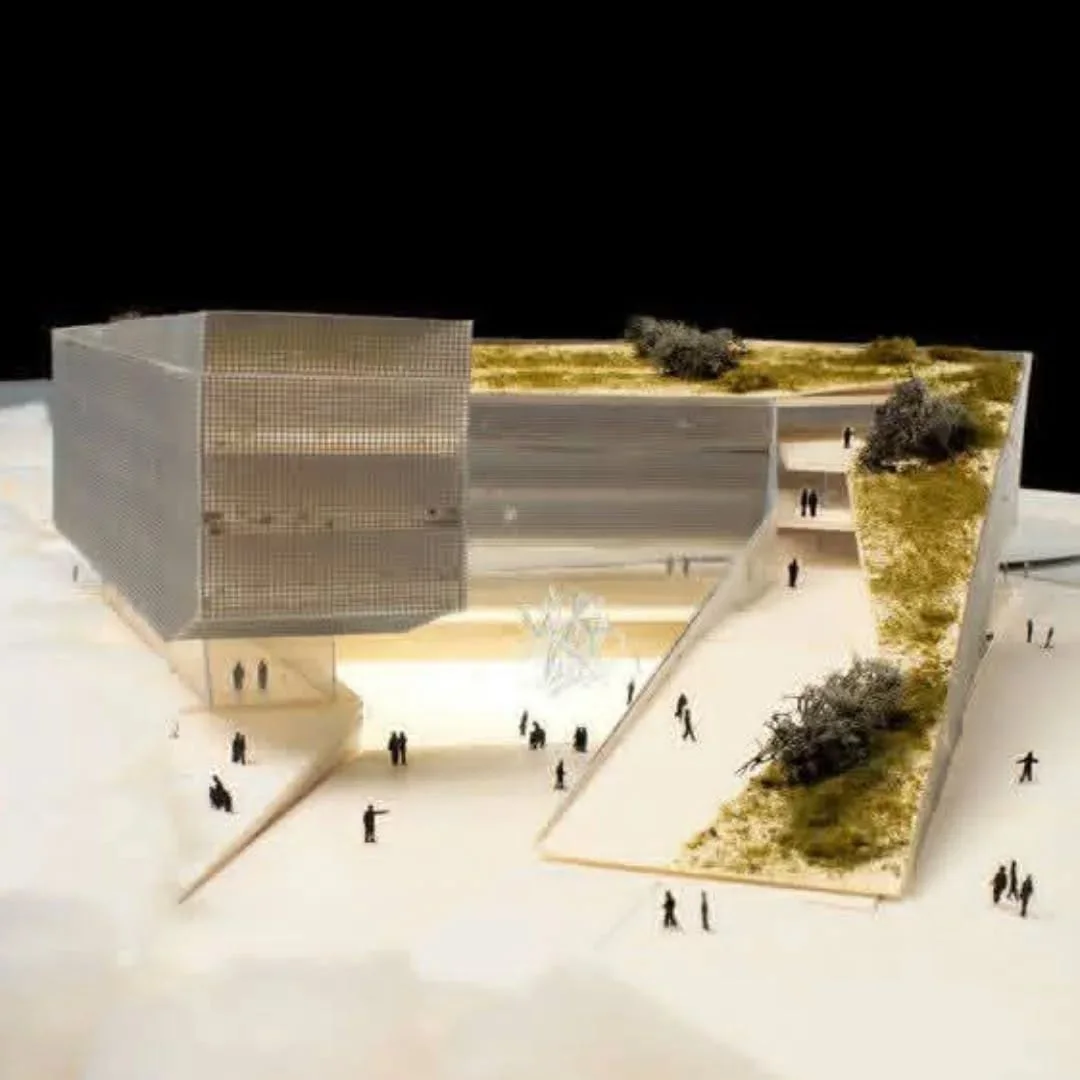 Scale model of a museum by Mario Cucinella Architects with landscaped roof and tiny figures in a plaza