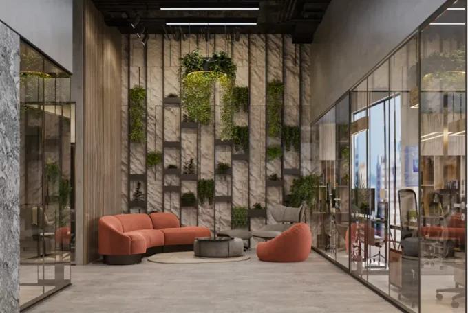 Office lobby with a planted shelving wall, coral sofas and glazed partitions
