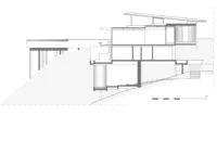 Section through stacked levels stepping down the steep ground, Pedra Azul House by Escala Arquitetura