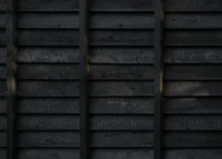 Close view of the cracked, blackened surface of the Yakisugi cladding boards, The Yakisugi Cabin