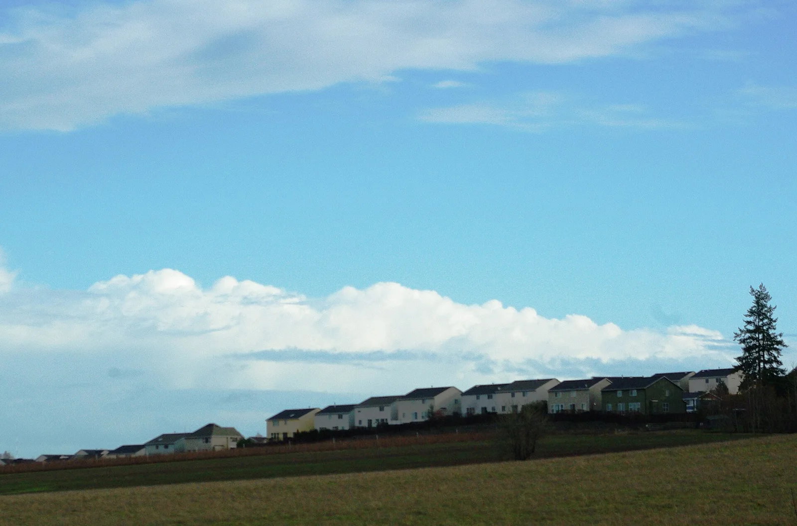 Farmland meeting suburban housing at the Portland urban growth boundary, a line that holds development inside the city