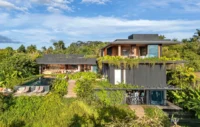 House seen from the bottom of the sloping garden with terraces, steps and trailing greenery, Vista House by Studio Gontijo Arquitetura